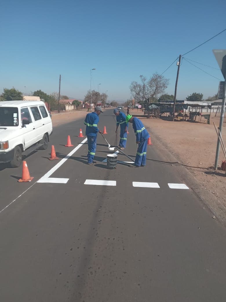 SealFix crew painting pedestrian crossing line markings